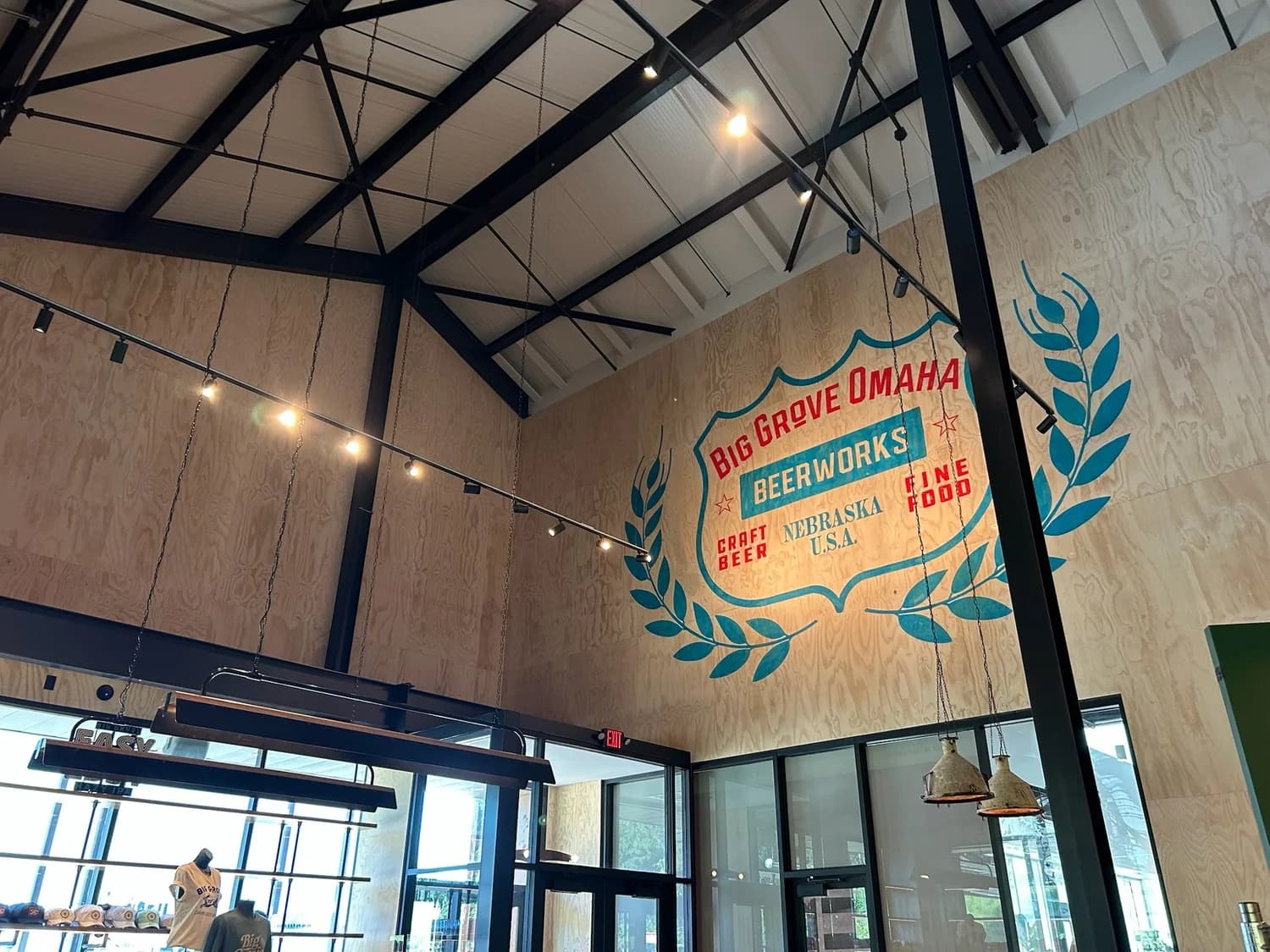 A painted plywood feature wall and steel trusses at Big Grove Brewery in Omaha