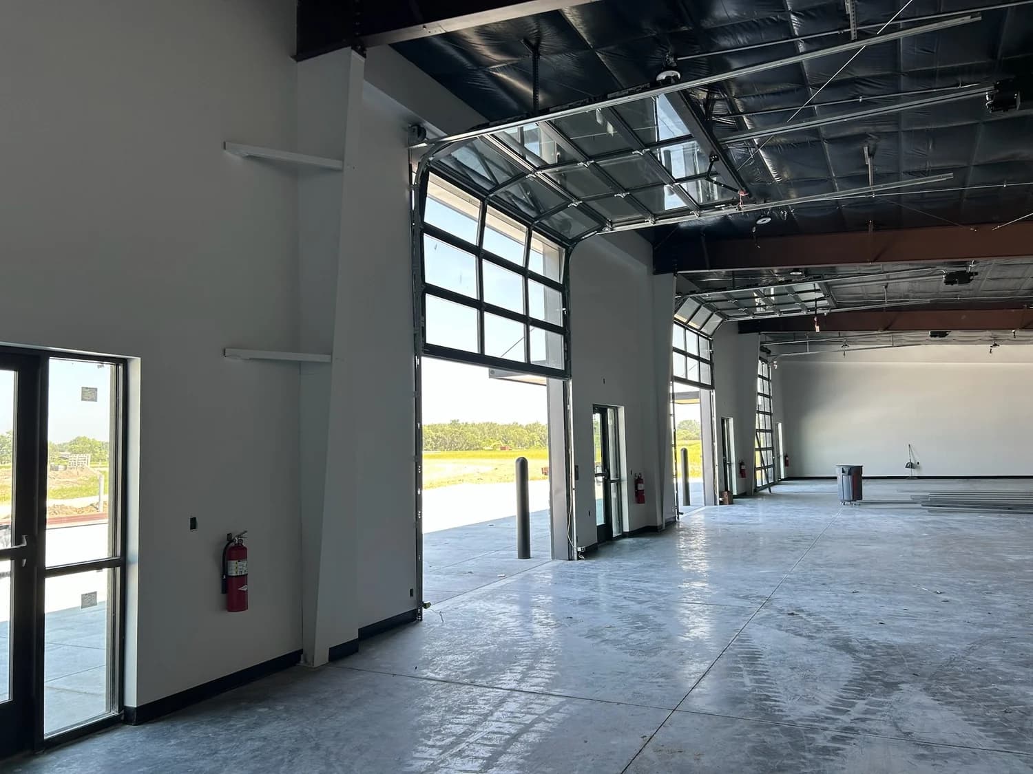 A new commercial bay with finished walls, ceilings and floor by DGR Painting Contractors